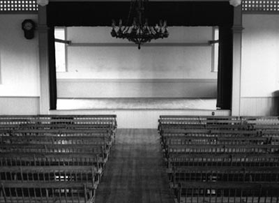 Black and white photo of an empty theatre by Matthew Buckingham entitled "Amos Fortune Road".