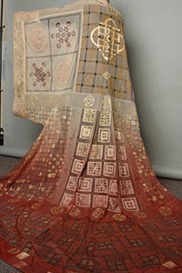 Photo of the costume worn by Pospero: a long gown with intricate patterning.