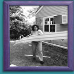 Framed photo of Helfand carrying away siding from her home.