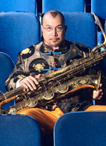 Photo of Fred Ho with his saxophone.