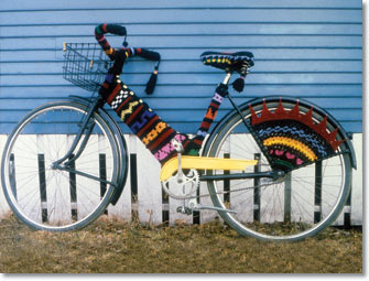 Image of a bicycle wearing custom-made knitted coverings.