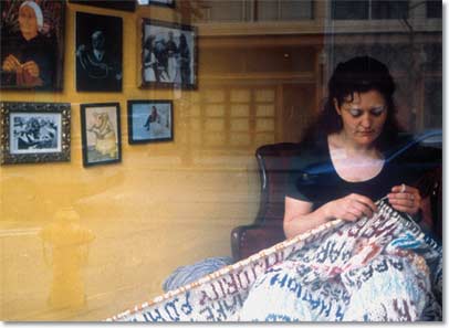 Photo of Janet Morton, knitting.
