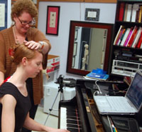 Photo of Professor Jessica Johnson teaching piano.